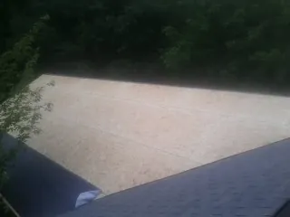 New OSB roof sheathing installed beside an existing shingle roof in West Springfield