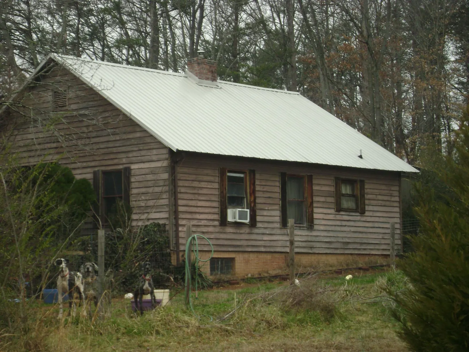 White metal roof on an old wood sided farmhouse, from a Metal Roof Installation job in West Springfield